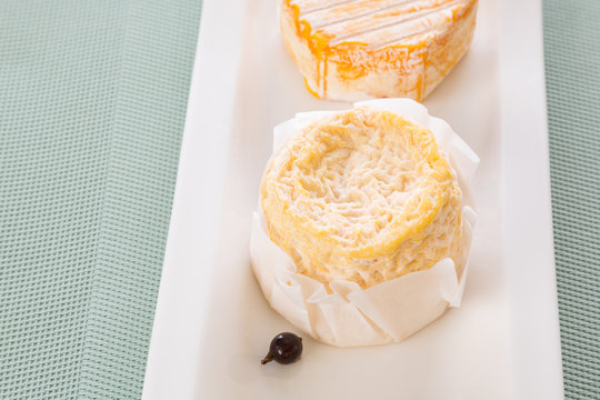 French cheese varieties camembert on a white plate in a box and without. dairy products. Free space for inscriptions.