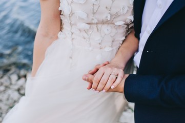 beautiful young couple just married on a walk by the lake