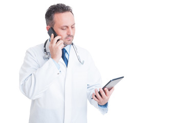 Smart medic or doctor multitasking with phone and tablet