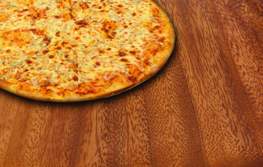 Cheese pizza on a wooden background