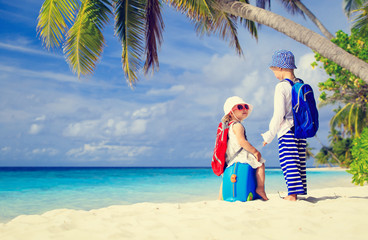 little boy and girl travel on summer tropical beach