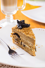 Piece of cake with cream, prunes 
