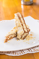 Napoleon cake on plate on table close-up