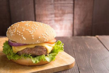 Cheeseburgers on buns with succulent beef on the wooden backgrou