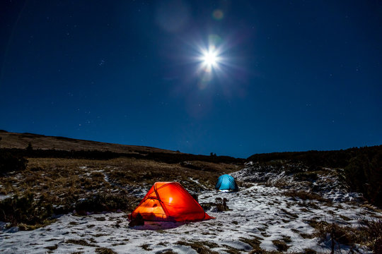 Winter Sport Hiking Bivouac in Mountain Landscape at Night with Bright Full Moon