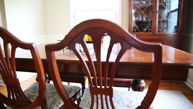 Dining Room Table Wide. 2 shots. camera rises and lowers on a old dining room table set.
