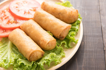 Fried Chinese traditional spring rolls on wooden table