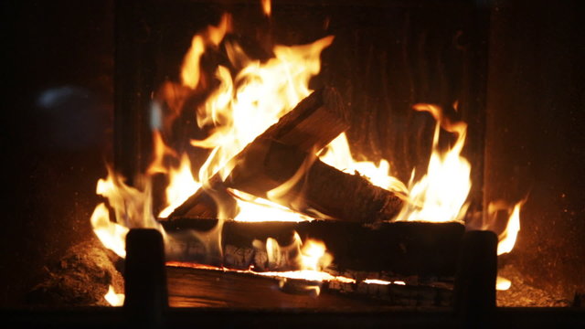 close up of firewood burning in fireplace