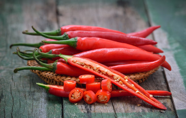  basket full of red chili peppers on wood