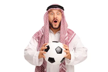 Keuken spatwand met foto Surprised young Arab holding a football © Ljupco Smokovski