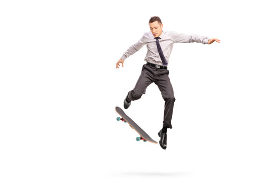 Businessman performing a trick with a skateboard