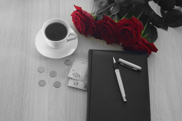 coffee with roses and money on the table