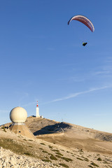 Fototapeta na wymiar Paraglider moving away from the top of Mont Ventoux