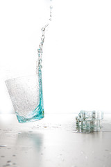 Water splashing from glass isolated on white background