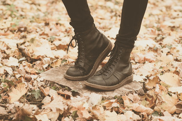 Girl in leather boots in the forest