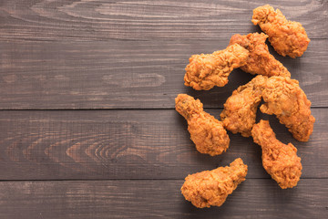 Fried chicken drumstick on the wooden background