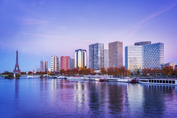 Fototapeta premium Paris skyline, Eiffel tower and buildings at sunset, reflection in the river Seine
