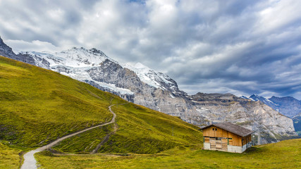 Fototapeta na wymiar Fairy tale house with a beautiful mountain range in the background
