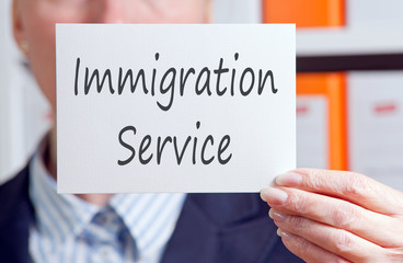 Immigration Service - Businesswoman with sign in the office