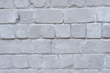 Gray wall of cinder block in whitewash.