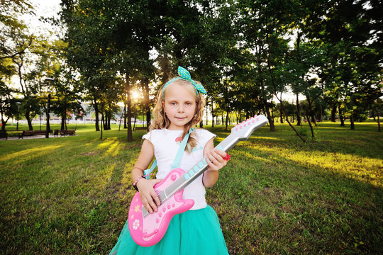 baby girl with a toy guitar