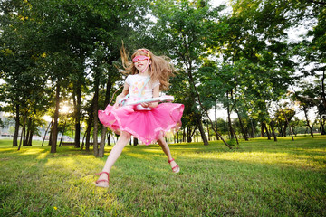 baby girl jumping with a toy guitar