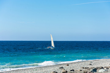 A small sailing yacht floating on the sea.