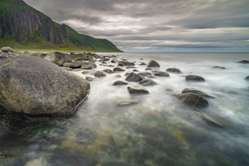 Coastal view in Norway, a silky sea from a slow shutter speed emphasizes the scene
