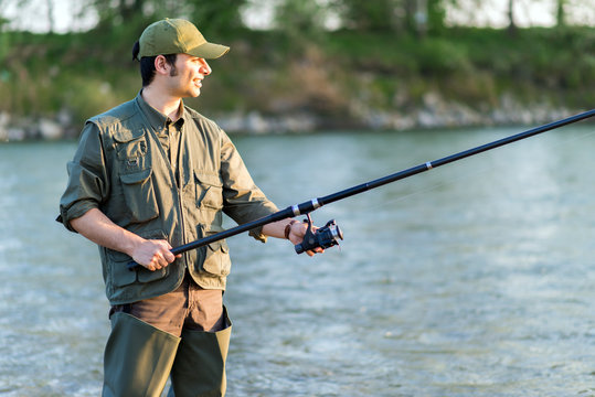 Young Fisherman Fishing In The River