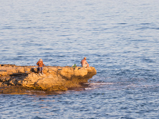 Fishermen on the cliff in the early morning