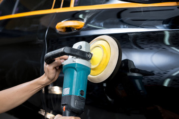 Car polishing series : Worker waxing black car