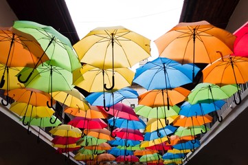 Street decoration with colorful open umbrellas hanging over the alley. Kosice, Slovakia