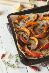 Slices of roasted pumpking on the baking sheet