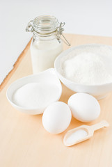 Fototapeta na wymiar Baking ingredients: milk, sugar, flour, eggs, salt