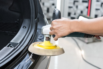 Car polishing series : Worker waxing black car