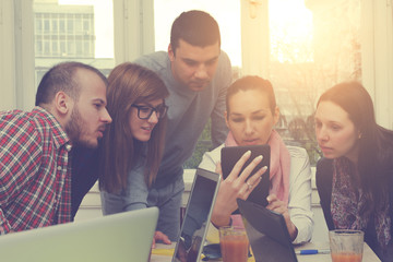 Young group of people discussing business plans.