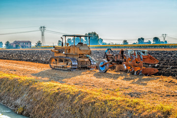 old tractor plowing a field