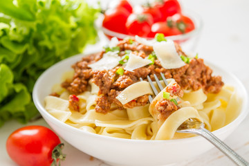 Spaghetti bolognese with salad and tomatoes