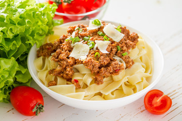 Spaghetti bolognese with salad and tomatoes