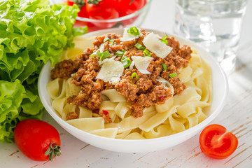 Spaghetti bolognese with salad and tomatoes
