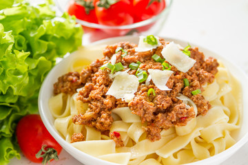 Spaghetti bolognese with salad and tomatoes