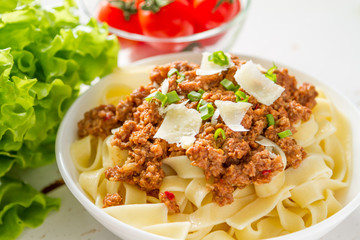 Spaghetti bolognese with salad and tomatoes