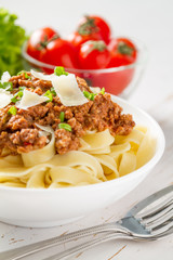 Spaghetti bolognese with salad and tomatoes