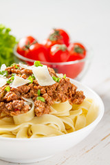 Spaghetti bolognese with salad and tomatoes