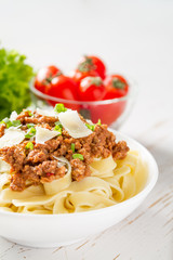 Spaghetti bolognese with salad and tomatoes