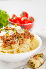 Spaghetti bolognese with salad and tomatoes