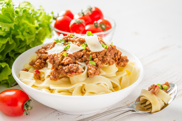 Spaghetti bolognese with salad and tomatoes