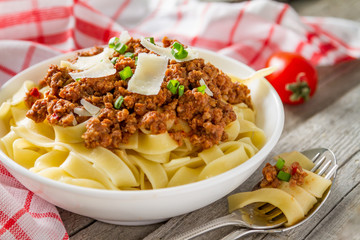 Spaghetti bolognese with salad and tomatoes
