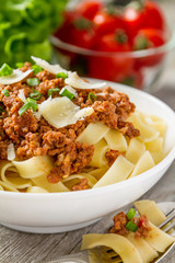 Spaghetti bolognese with salad and tomatoes
