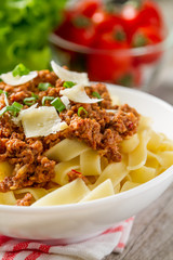 Spaghetti bolognese with salad and tomatoes